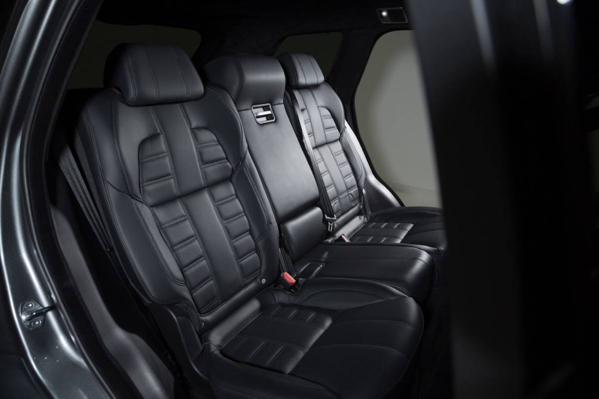Three luxurious black leather seats in a modern car interior, showcasing sleek design and premium cushioning.